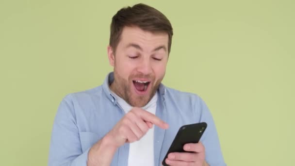 Young Man Smartphone His Hands Looks Shocked Surprised Wow Pointing — Stock Video