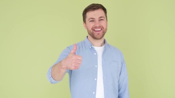 Young Handsome Man Beard Denim Shirt Yellow Green Background Sign – Stock-video