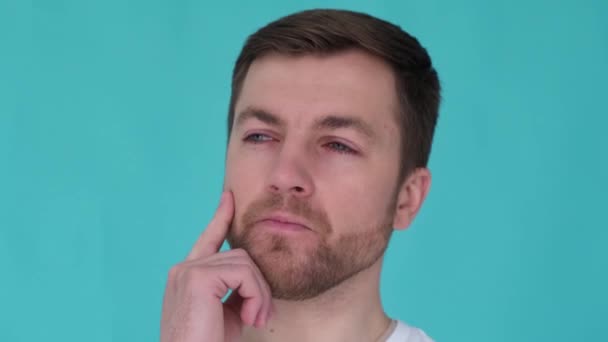 Close Portrait Pensive Man Turquoise Background Studio Guy Thinking Touching — Stockvideo