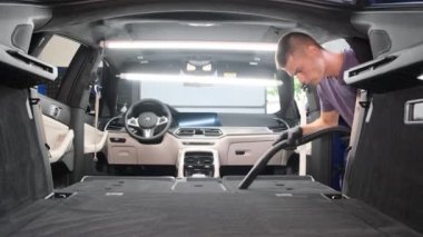 Cleaning the interior of a car by an employee of a cleaning station.Professional interior cleaning.