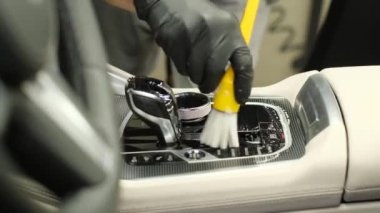 Car wash services cleaning the car with a brush. Car detailing. Cleaning with brush.
