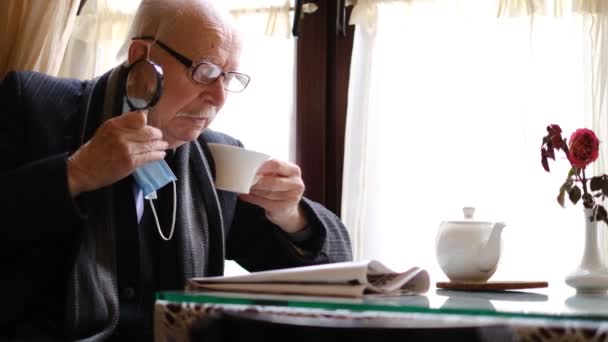 Old Grandfather Reads Latest News Newspaper Table Pensioner Resting Drinking — Video