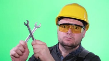 Smiling car mechanic standing looking at camera on chromakey background, portrait of car mechanic in uniform. Car repair concept