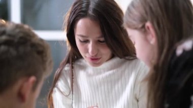 Beautiful young mother having fun with children. A family playing at home on the weekends.
