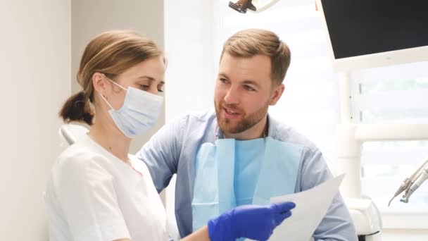 Satisfied Patient Discusses Dental Treatment Plan Female Dentist Modern Approach — 图库视频影像