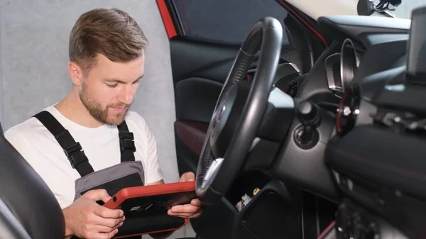 The mechanic maintains the vehicle with the help of diagnostic computer equipment - modern equipment in the car service. The latest computer diagnostics of the car.