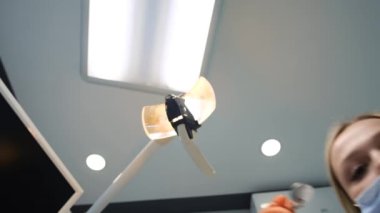 In the dental office. The dentist examines the oral cavity. Foreshortening from below.