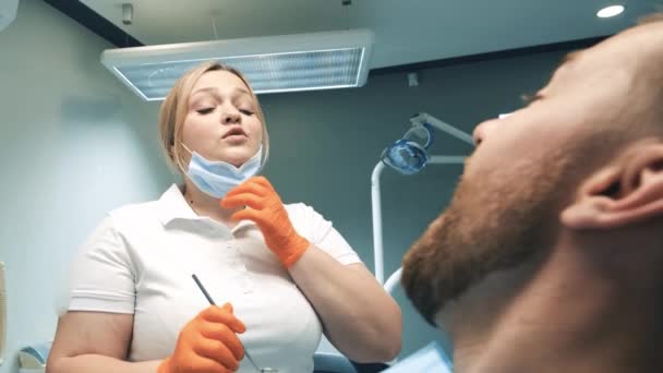 Young Blonde Doctor Treats Young Mans Teeth Patient Sits Dentists — Video