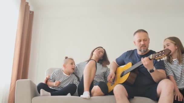 Dad Man Playing Guitar His Family While Sitting Sofa Relaxing — Stock Video