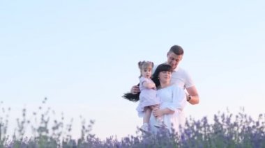 Çocuklu şık bir aile lavanta tarlasında yürüyor. Yakışıklı bir adam güzel bir esmer kadının elini tutar, birlikte geçirdiğimiz anların tadını çıkarır, gün batımıyla karşılaşır. Yüksek kaliteli video 4k