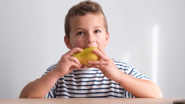 Petit Garçon Mange Une Poire Juteuse Regarde Caméra Fruits Mûrs — Video