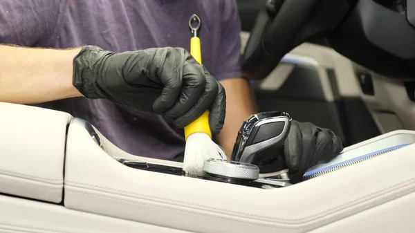 Professional dry cleaning of the car interior. Hands in rubber black gloves for cleaning the car. Close up