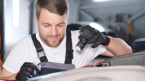 Zbliżenie Zadowolonej Atrakcyjnej Mechaniki Samochodowej Latarką Terminowa Naprawa Samochodu Garażu — Zdjęcie stockowe