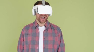 A focused man in a VR headset looks straight ahead. Technology concept. High quality 4k video. Modern virtual reality technologies