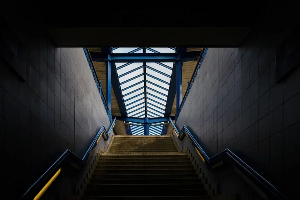 The steps go up. Metro stop, railway station. Stair inside the metro, subway with cleanly steel handrail. modern platform with granite staircase.