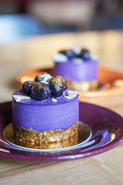 Purple sweet cake, small baked dessert with purple and gold coloring. Beautiful and delicious food, sweet food.