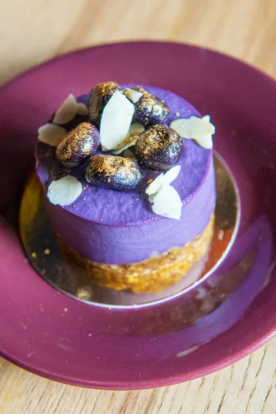 Purple sweet cake, small baked dessert with purple and gold coloring. Beautiful and delicious food, sweet food.