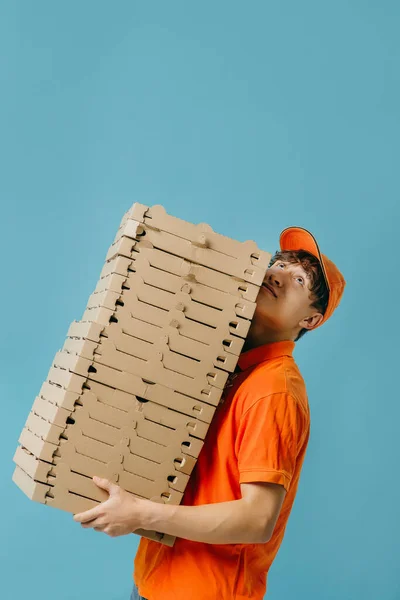 Pizza delivery concept. Pizza delivery man with lots of pizza boxes. Photo mockup.