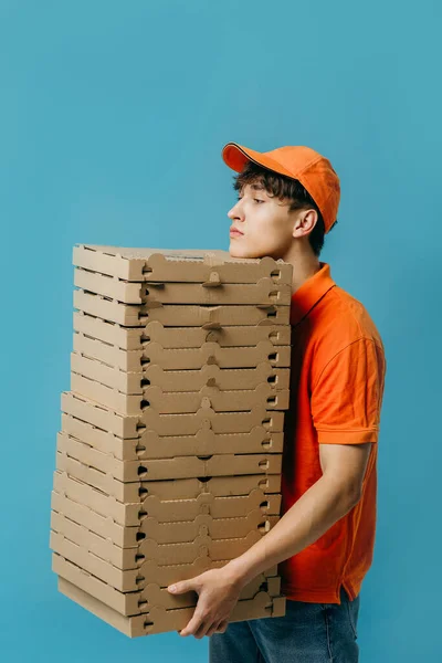 Pizza delivery concept. Pizza delivery man with lots of pizza boxes. Photo mockup.