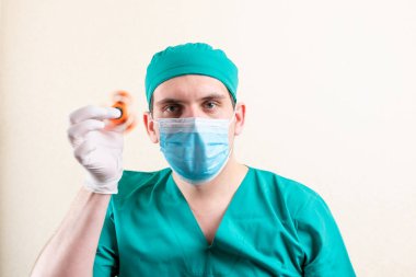 Elinde fırıldak olan maske ve eldivenli bir doktor. Yüksek kalite fotoğraf