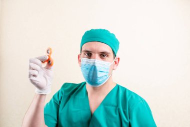 Elinde fırıldak olan maske ve eldivenli bir doktor. Yüksek kalite fotoğraf