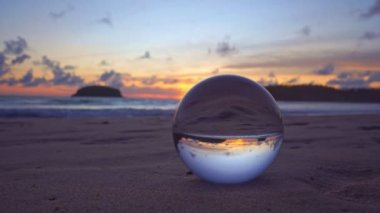 view of beautiful sky at sunset inside crystal ball.The natural view of the sea and sky in beautiful sunset are unconventional and beautiful inside crystal ball.Nature video High quality footage.