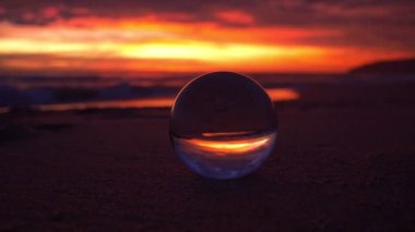 view of beautiful sky at sunset inside crystal ball.The natural view of the sea and sky in beautiful sunset are unconventional and beautiful inside crystal ball.Nature video High quality footage.