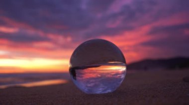 view of beautiful sky at sunset inside crystal ball.The natural view of the sea and sky in beautiful sunset are unconventional and beautiful inside crystal ball.Nature video High quality footage.