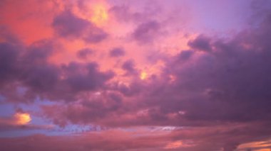 scenery pink cloud in purple sky of sunset above the ocean. purple clouds cover the ocean during colorful cloud in sunset at Kata beach Phuket.video 4K. Scene of pink light in the sky background.