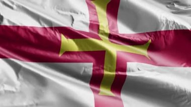 Guernsey bayrağı rüzgarda sallanıyor. Gernian bayrağı rüzgarda sallanıyor. Tam dolgu arkaplanı. 10 saniye döngü. 