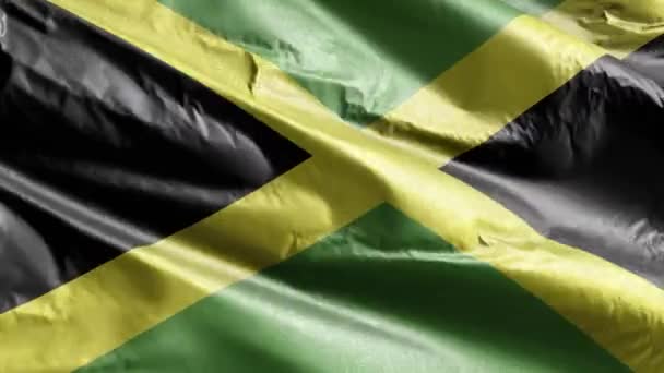 ジャマイカの繊維旗が風になびいている ジャマイカの旗が風に揺れる 繊維組織だ 完全充填の背景 10秒ループ — ストック動画