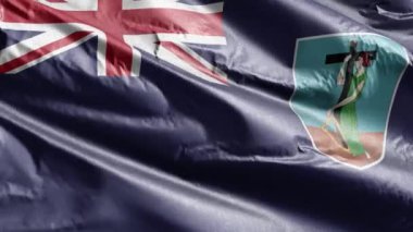 Montserrat tekstil bayrağı rüzgar döngüsünde yavaşça dalgalanıyor. Montserrat bayrağı rüzgarda sallanıyor. Kumaş dokular. Tam dolgu arkaplanı. 20 saniye döngü. 