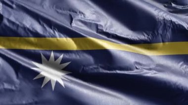 Nauru tekstil bayrağı rüzgar döngüsünde yavaşça dalgalanıyor. Naursky bayrağı rüzgarda sallanıyor. Kumaş dokular. Tam dolgu arkaplanı. 20 saniye döngü. 
