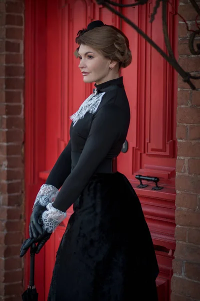 Genç Bir Aristokrat Kadın Evin Kırmızı Kapısının Yanında Duruyor — Stok fotoğraf