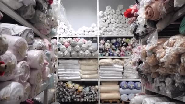 View of a rack with rolls of multicolored fabrics — Stock Video