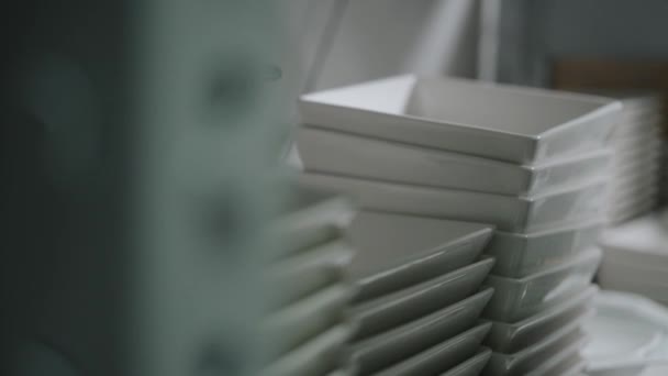 Stacks of plates standing on shelves — Stockvideo
