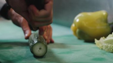 Şef profesyonel olarak salatalığı dilimliyor. Yüksek kalite 4k görüntü