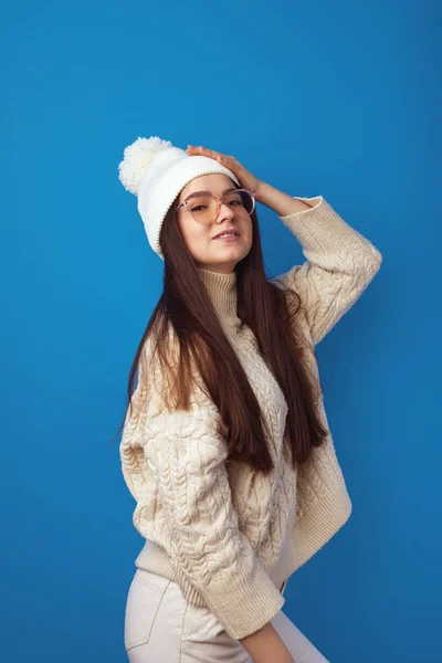 stock image Girl wears warm hat and oversized knitted sweater, feels joyful, enjoy winter