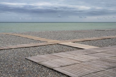 Beach hut and pebble beach in the town of Dieppe in Normandy