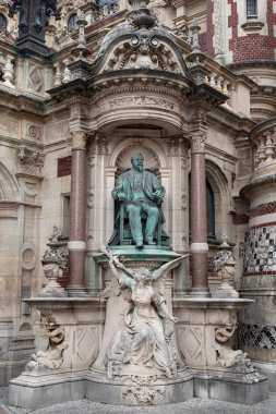 Detail of the exterior architecture of a gothic monastery with a statue in Fcamp, France