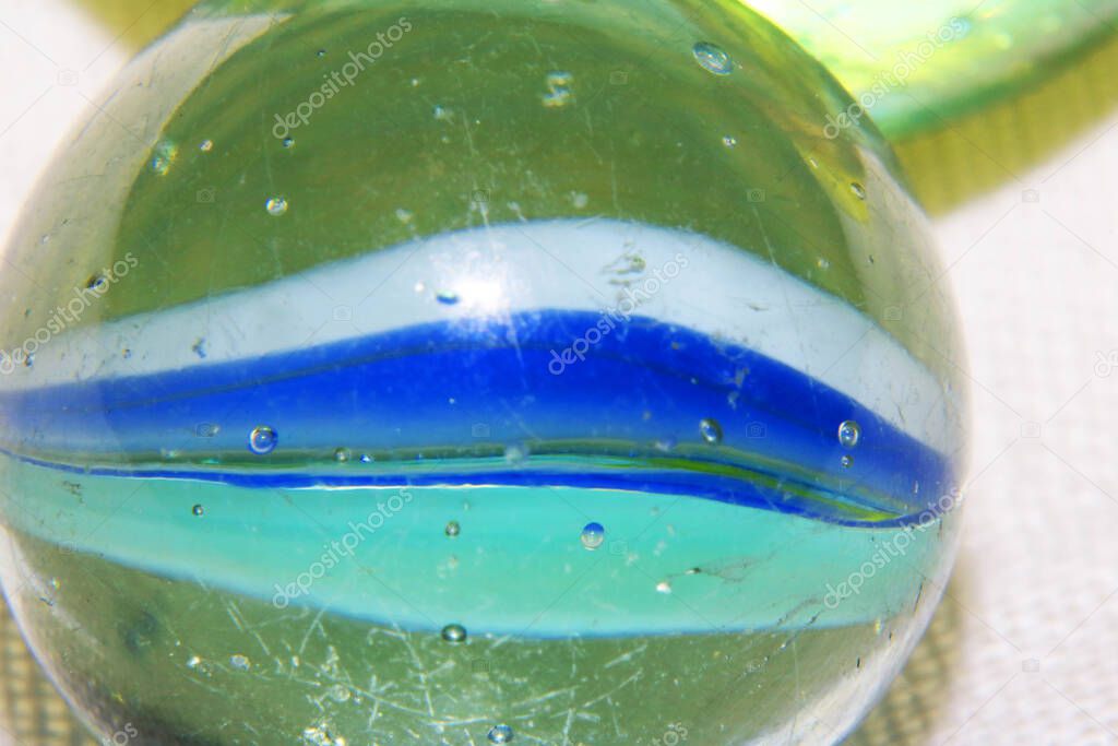 A Close Up of a Vintage Glass Marble With Swirls and Bubbles