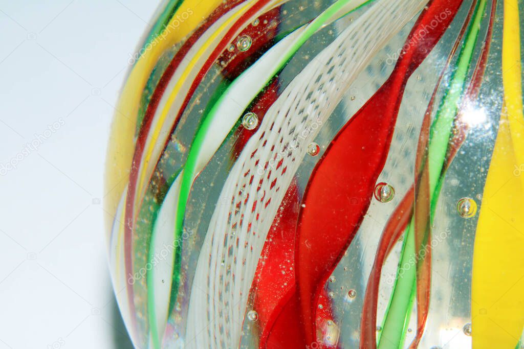A Vibrant Abstract Glass Swirls and Bubbles from a Paperweight with Lines and Colours