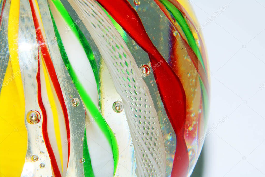 A Vibrant Abstract Glass Swirls and Bubbles from a Paperweight with Lines and Colours