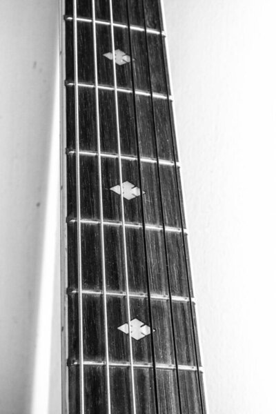 A Close Up of an Old Vintage Acoustic Guitar Strings and Neck