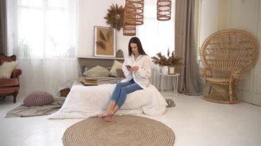 4k Lady in casual wear reading posts on social media on phone 