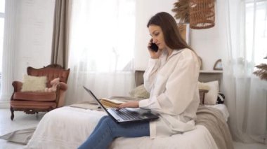 4k  Freelancer lady browsing internet while speaking phone 