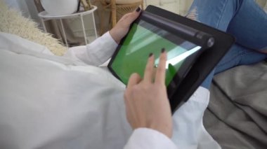 4k girl holding tablet computer with green screen