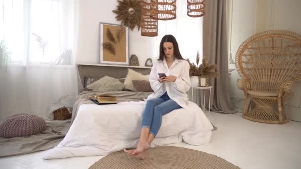 Entspannte Frau Hause Beim Lesen Einer Sms Ihrem Hellen Schlafzimmer — Stockvideo
