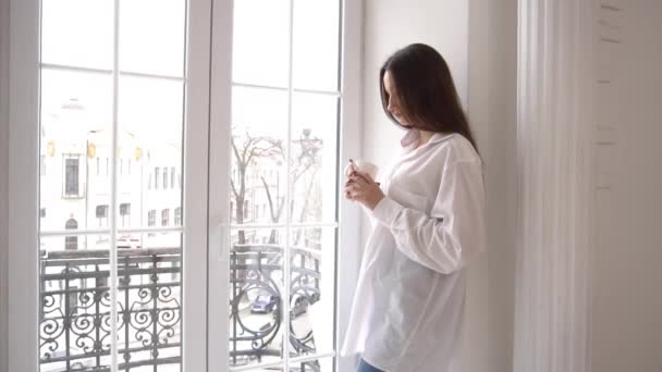 Woman Standing Drinking Coffee Window — 图库视频影像