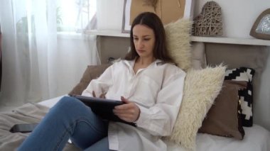 Slow Motion Girl holding digital tablet with blank screen and smiling at camera 